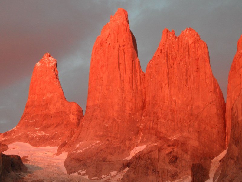 The granite towers of Torres del Paine glowing red at sunrise, Chilean Patagonia