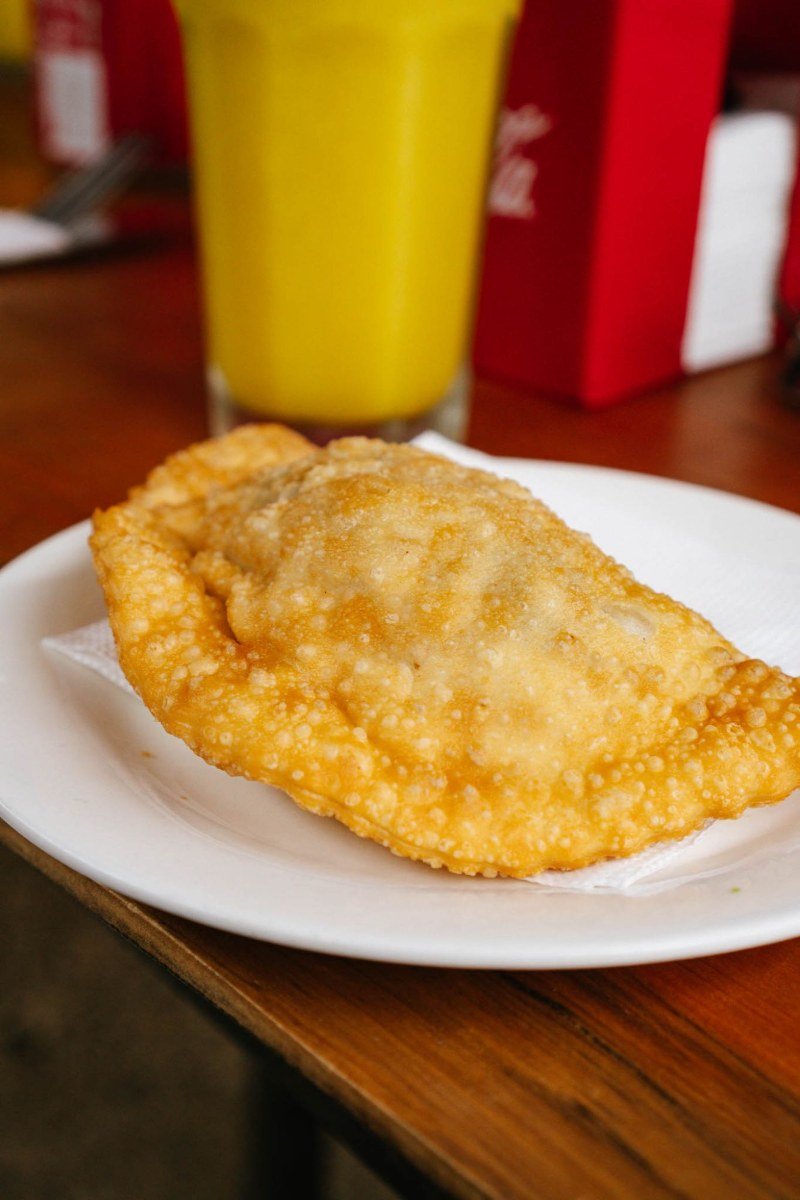 Fried empanada and fresh juice at a beach-side restaurant on the central coast