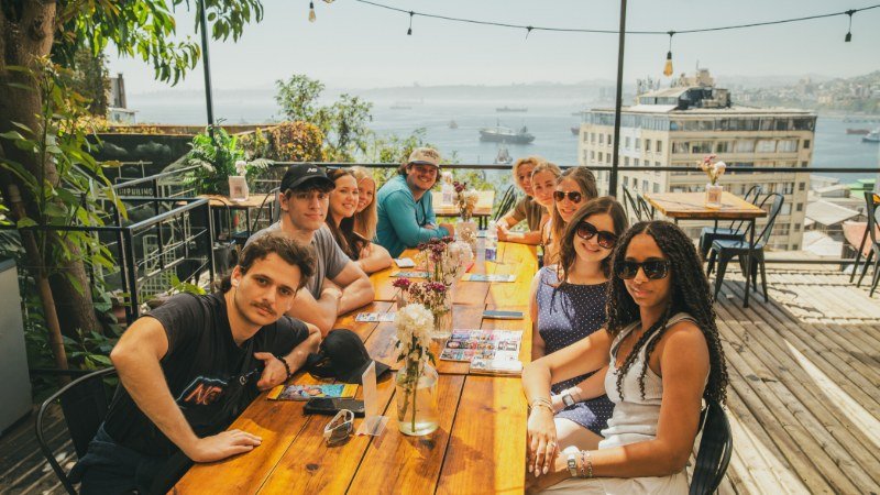 Group enjoying lunch on a rooftop terrace overlooking Valparaíso bay
